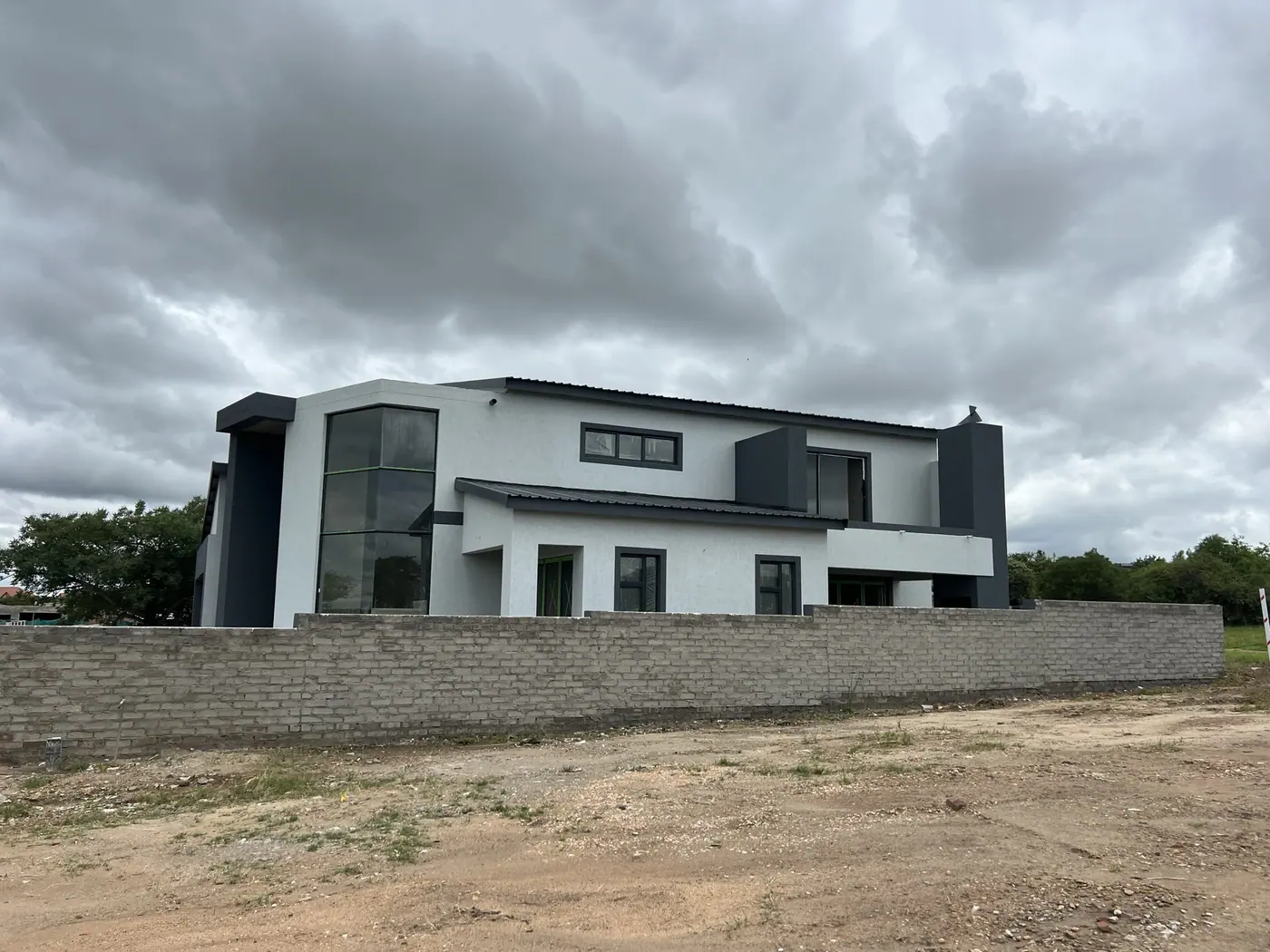 Completed double-storey house on a walled stand in Limpopo