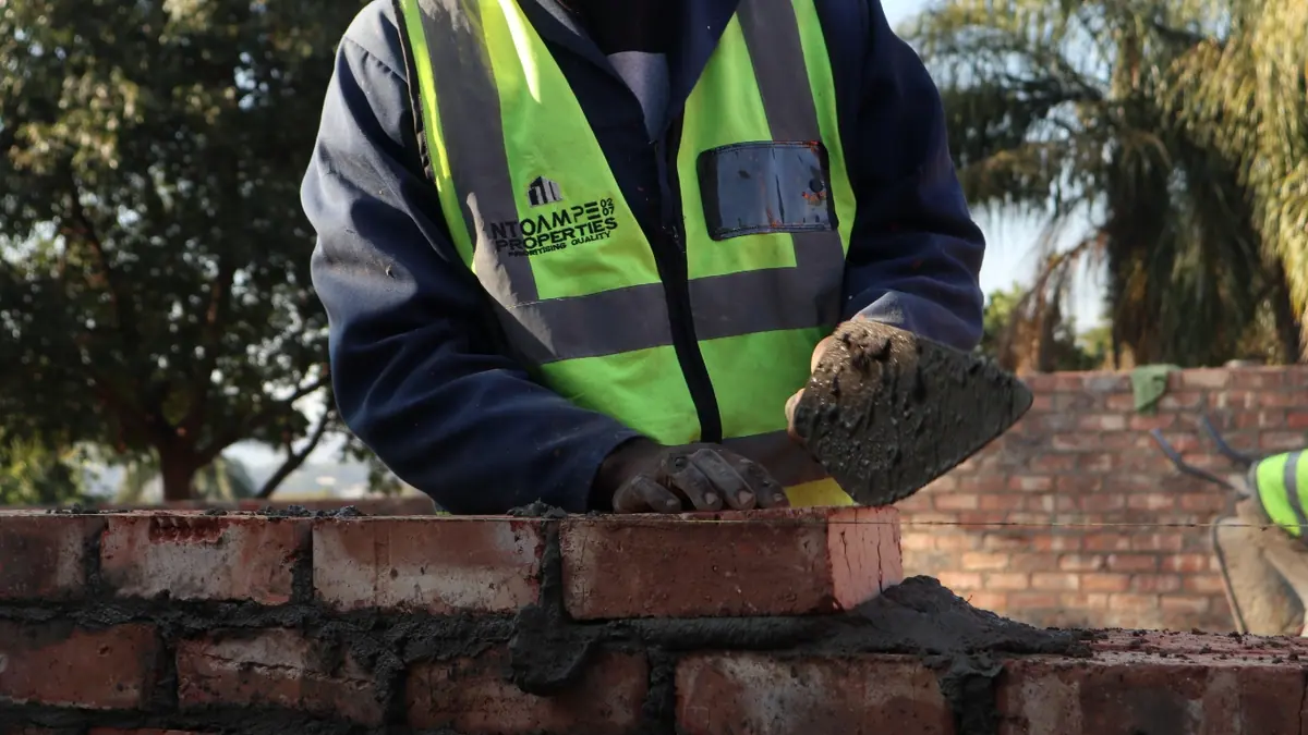Ntoampe 0207 Properties bricklayer laying a clay brick course on a Polokwane build