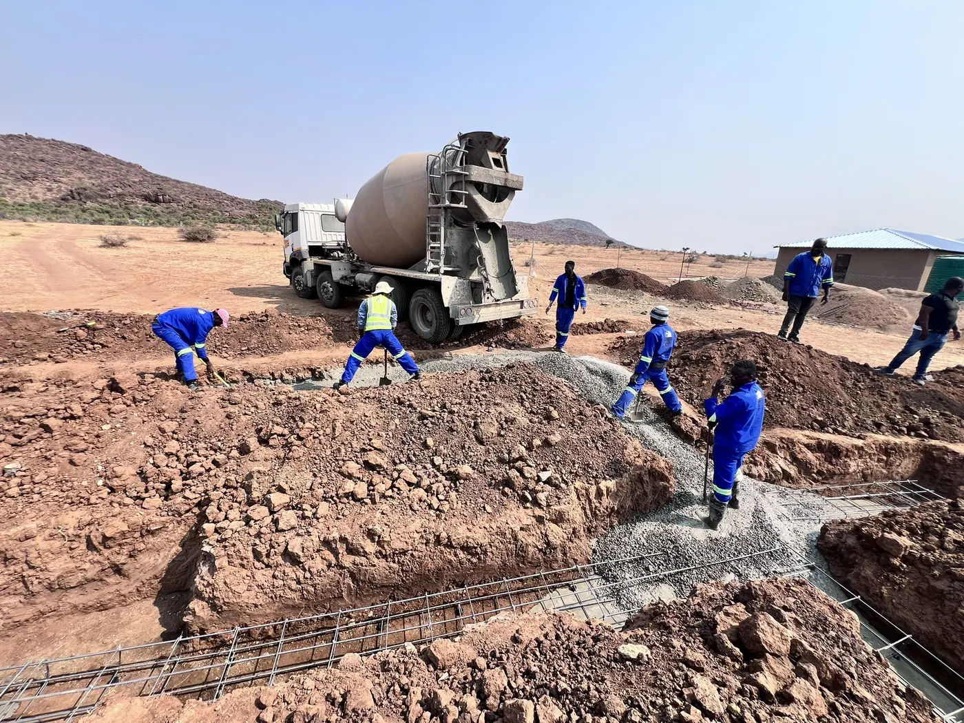 Ntoampe 0207 Properties crew placing concrete during earthworks on a rural Limpopo site
