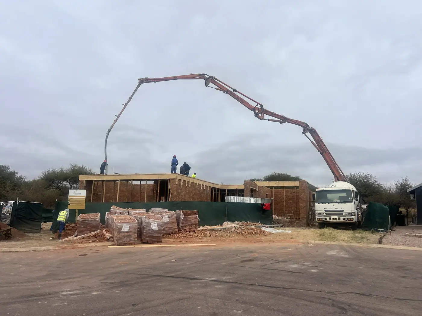 Concrete boom pump at work on a Ntoampe 0207 Properties residential build